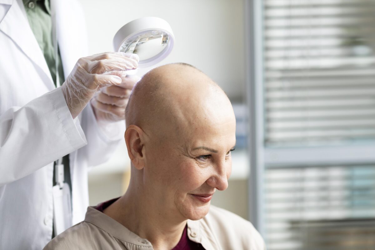 Doctor examining patient’s skin for signs of cancer at a cancer treatment center in India