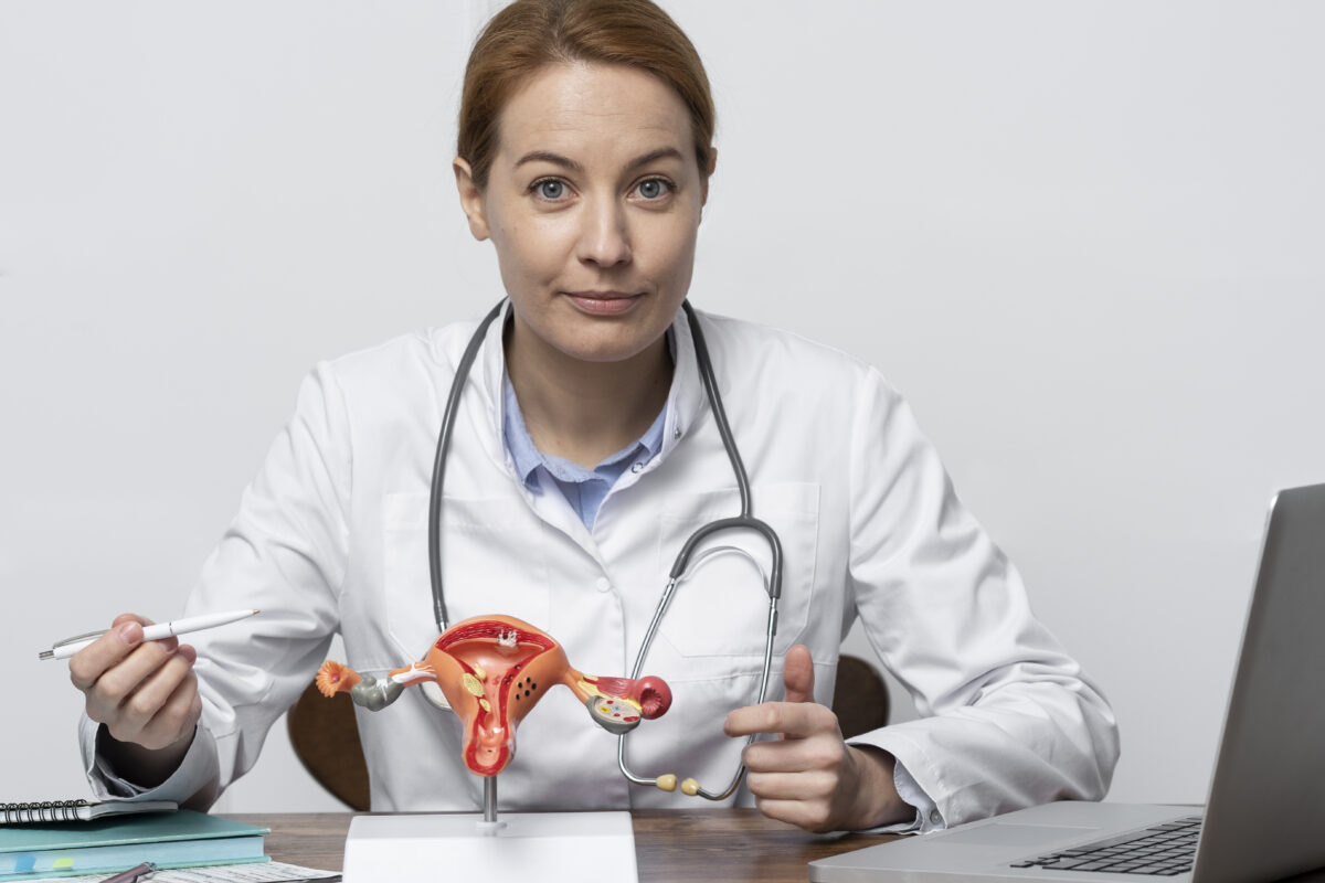 Doctor explaining cervical anatomy using a model during cervical cancer consultation in India