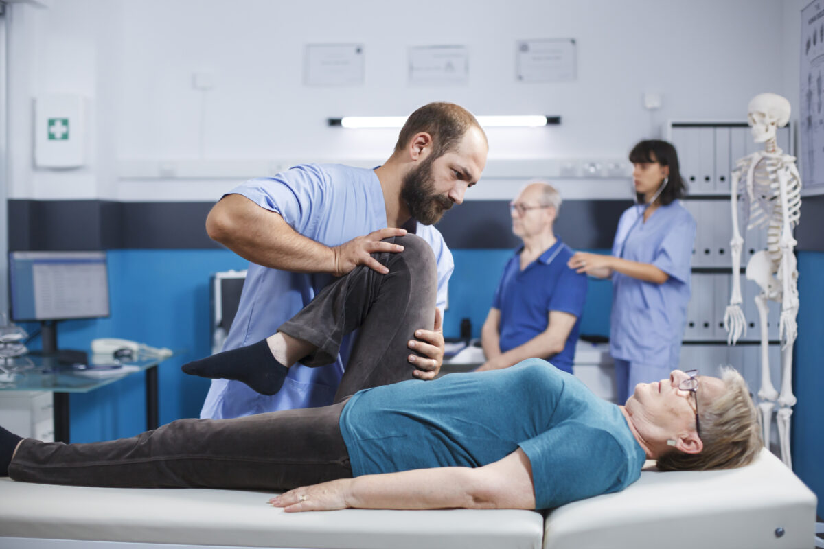 Female patient performing leg rehabilitation exercises under orthopedic supervision in Indian hospital