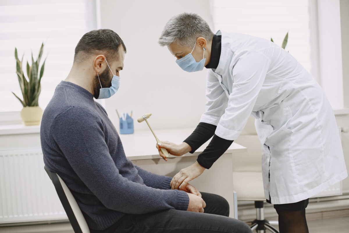 Doctor consulting with male patient in hospital during bone marrow transplant recovery in India