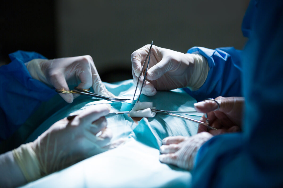Surgeons performing laparoscopic hysterectomy in a modern operation theater in India