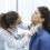 A doctor examining a woman’s neck for thyroid issues, representing diagnosis and treatment options like thyroid surgery in India.