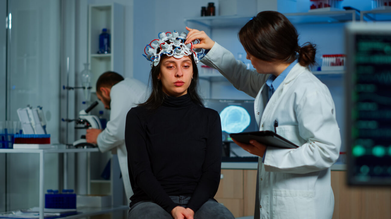 A neurologist adjusting a brain stimulation device on a patient’s head during a diagnostic session — representing advanced neurological care at Deep Brain Stimulation Surgery Hospitals in India.