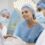 Breast cancer surgeons in India reviewing patient reports before surgery at a modern hospital.