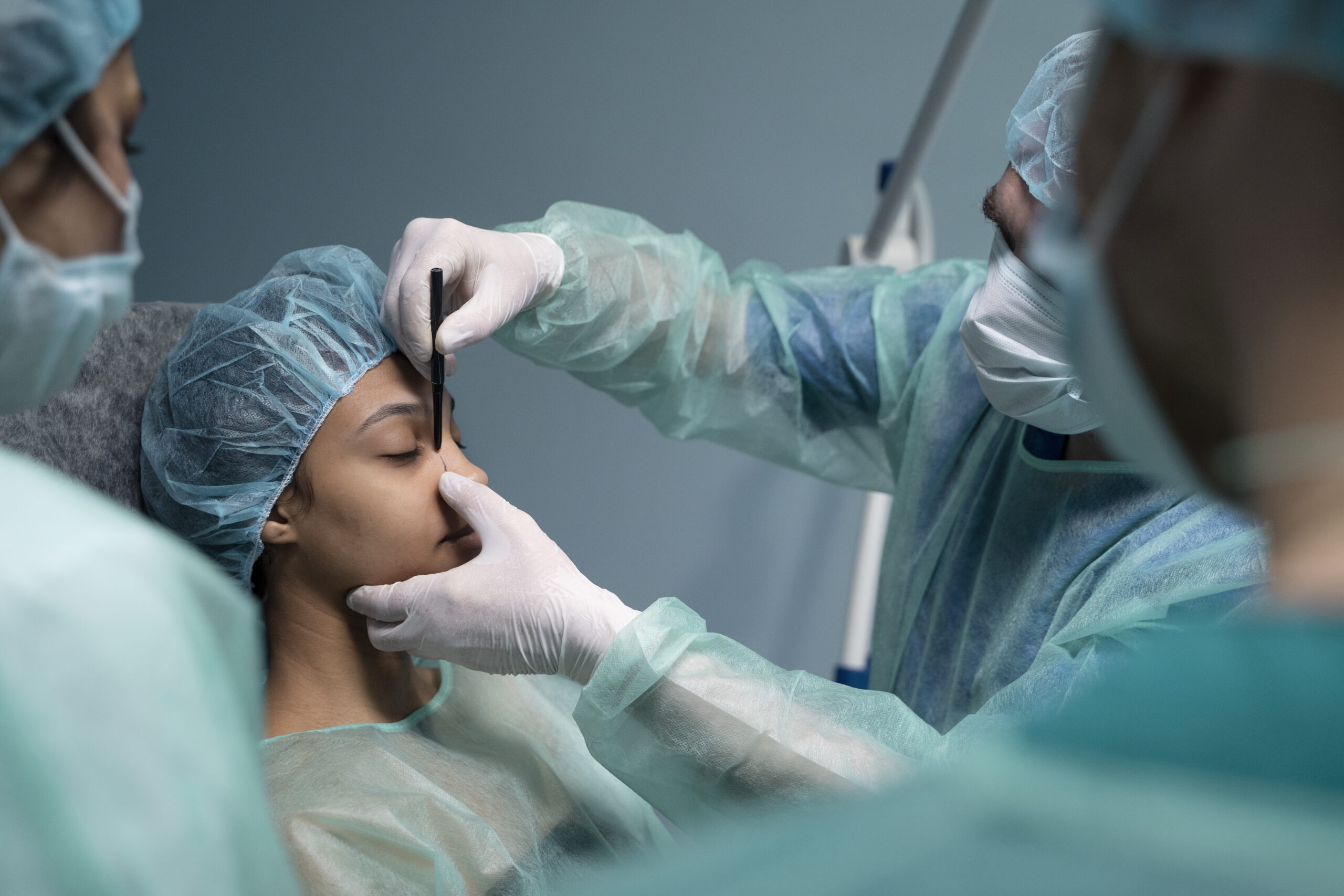 Plastic surgeons performing rhinoplasty procedure in a modern operating room at one of India’s leading plastic surgery hospitals.